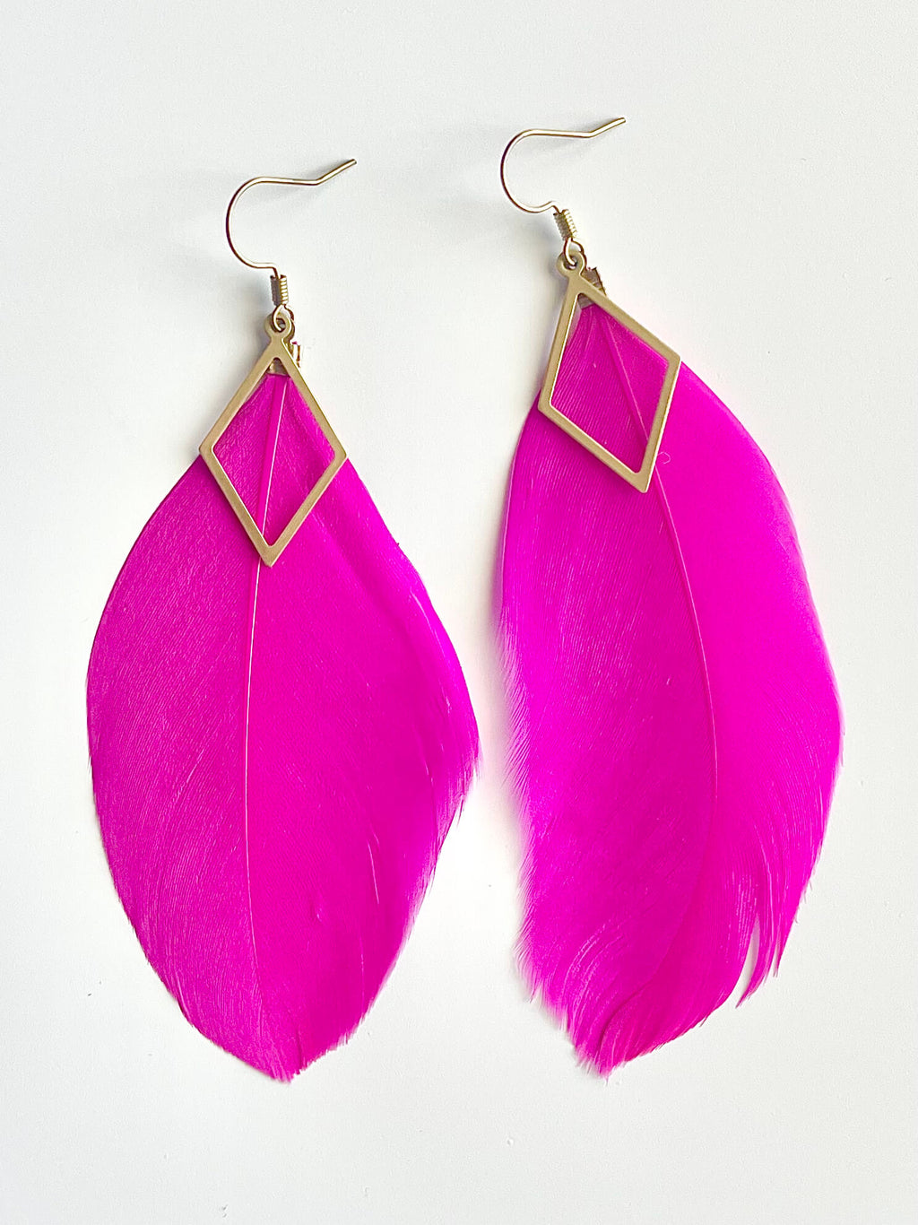 Pink feather earrings with gold accents on a white background
