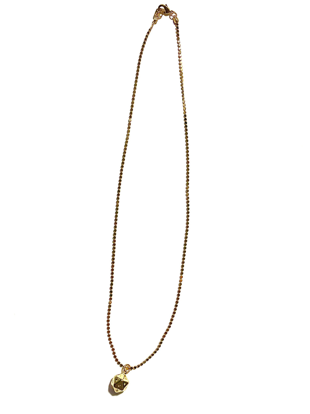 Gold plated polyhedral dice necklace on white background