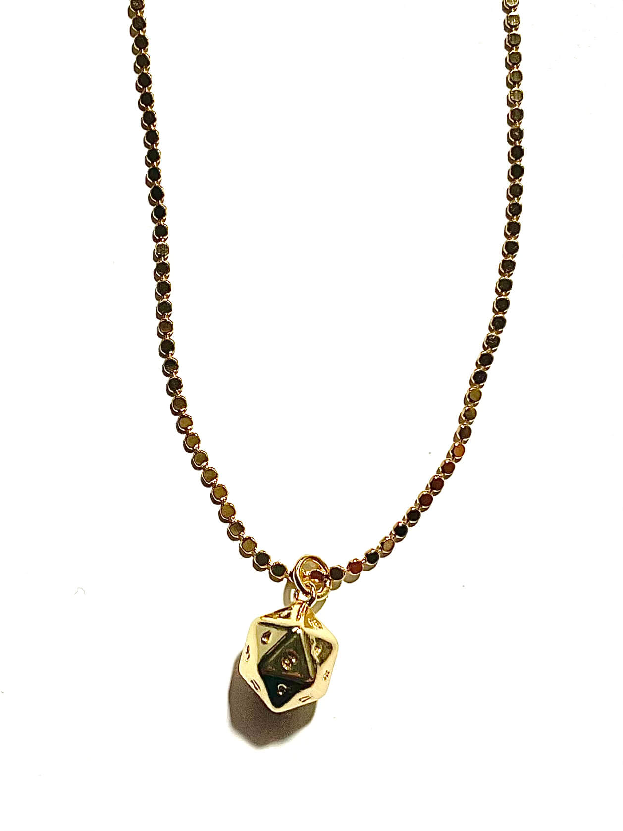Polyhedral dice charm on a dot chain and white background 