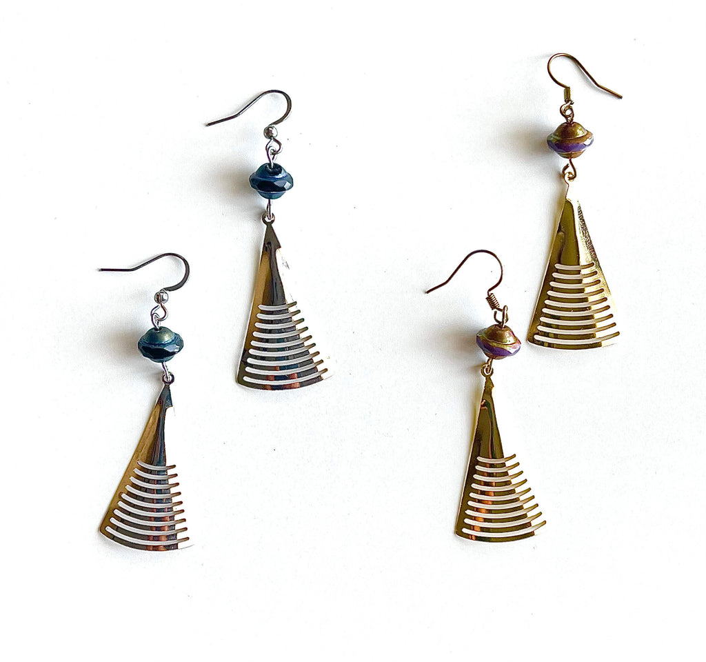 Pair of gold and blue spiral earrings on a white background