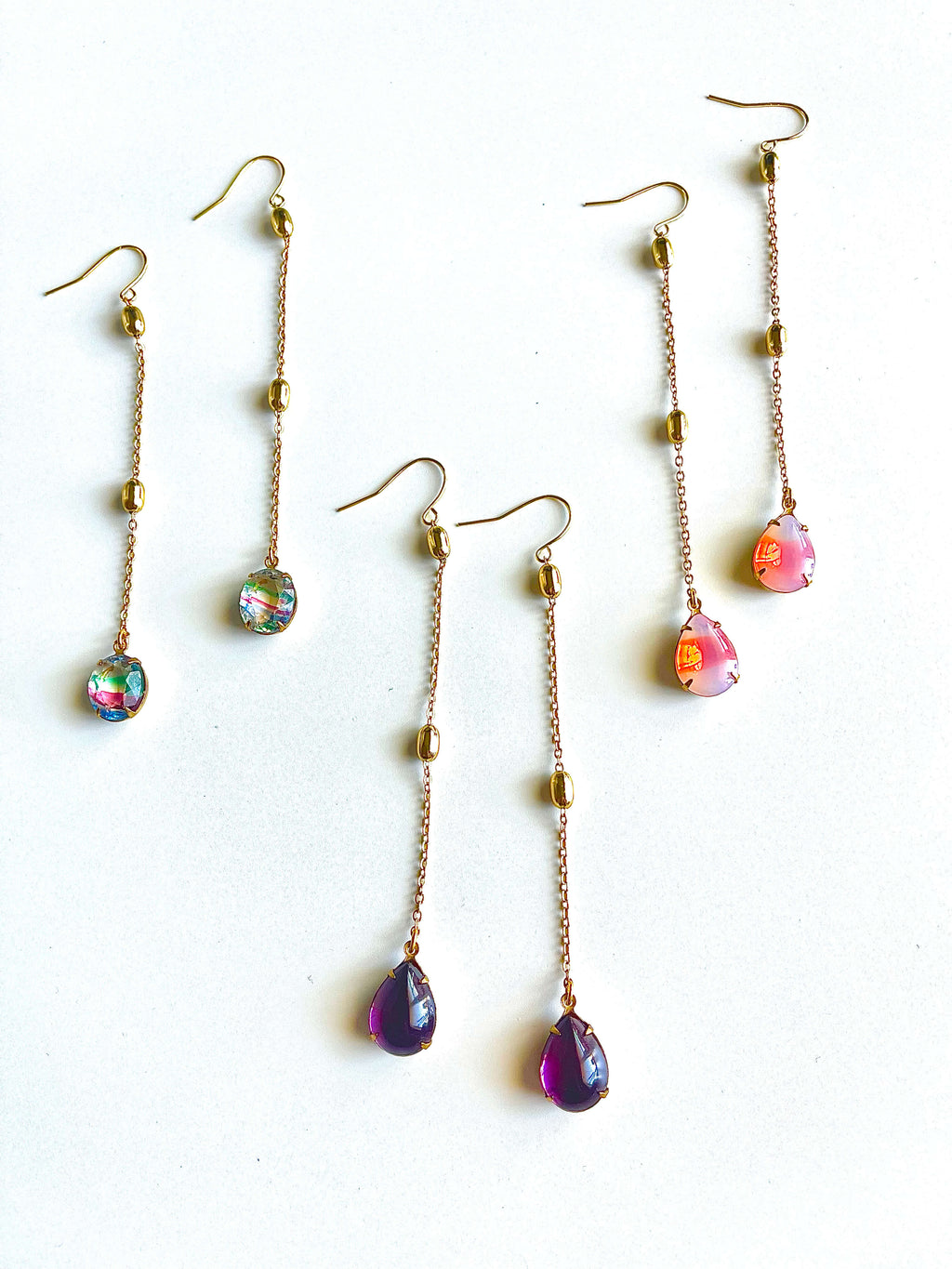 Set of colorful teardrop earrings on a white background