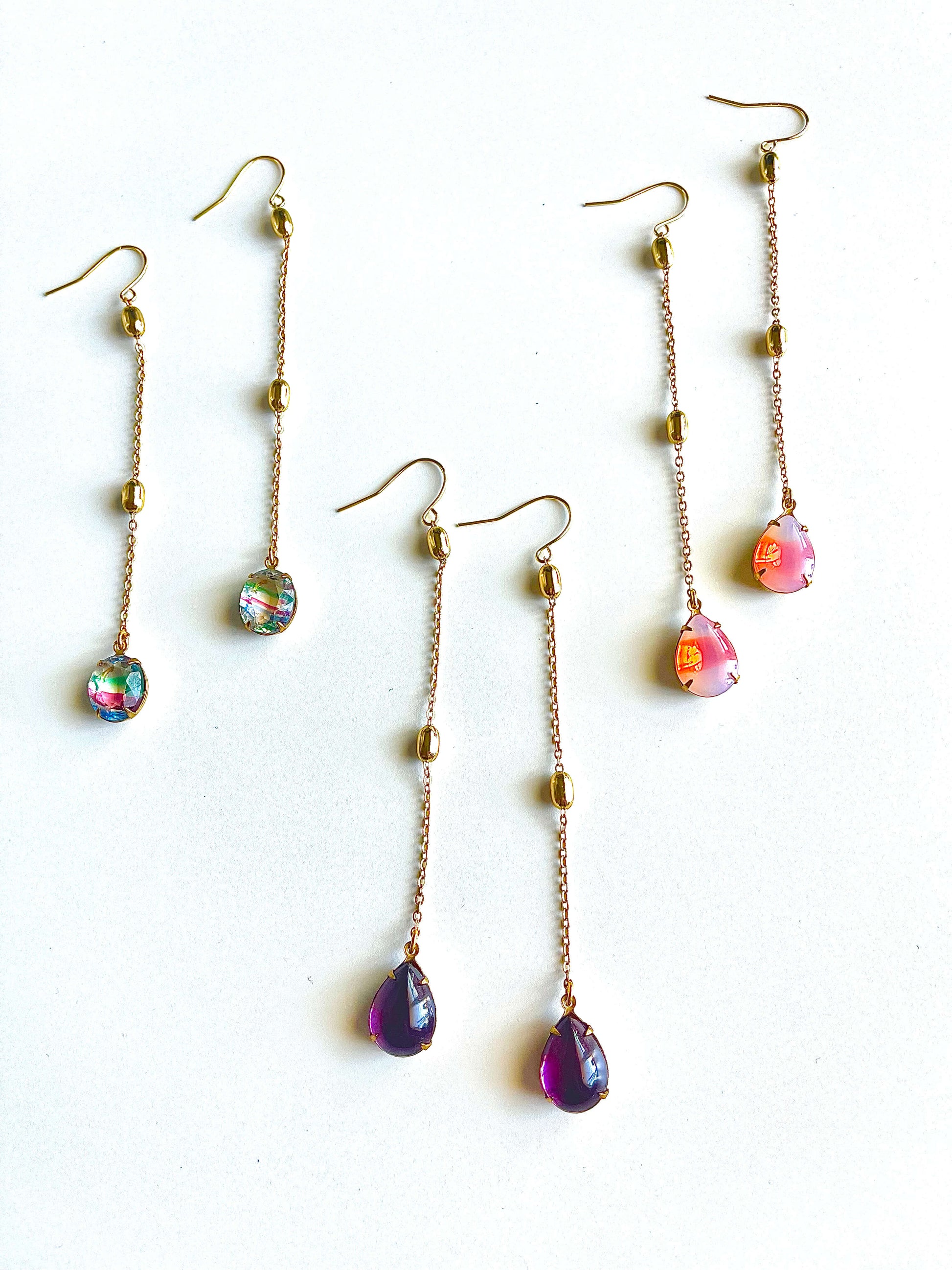 Set of colorful teardrop earrings on a white background