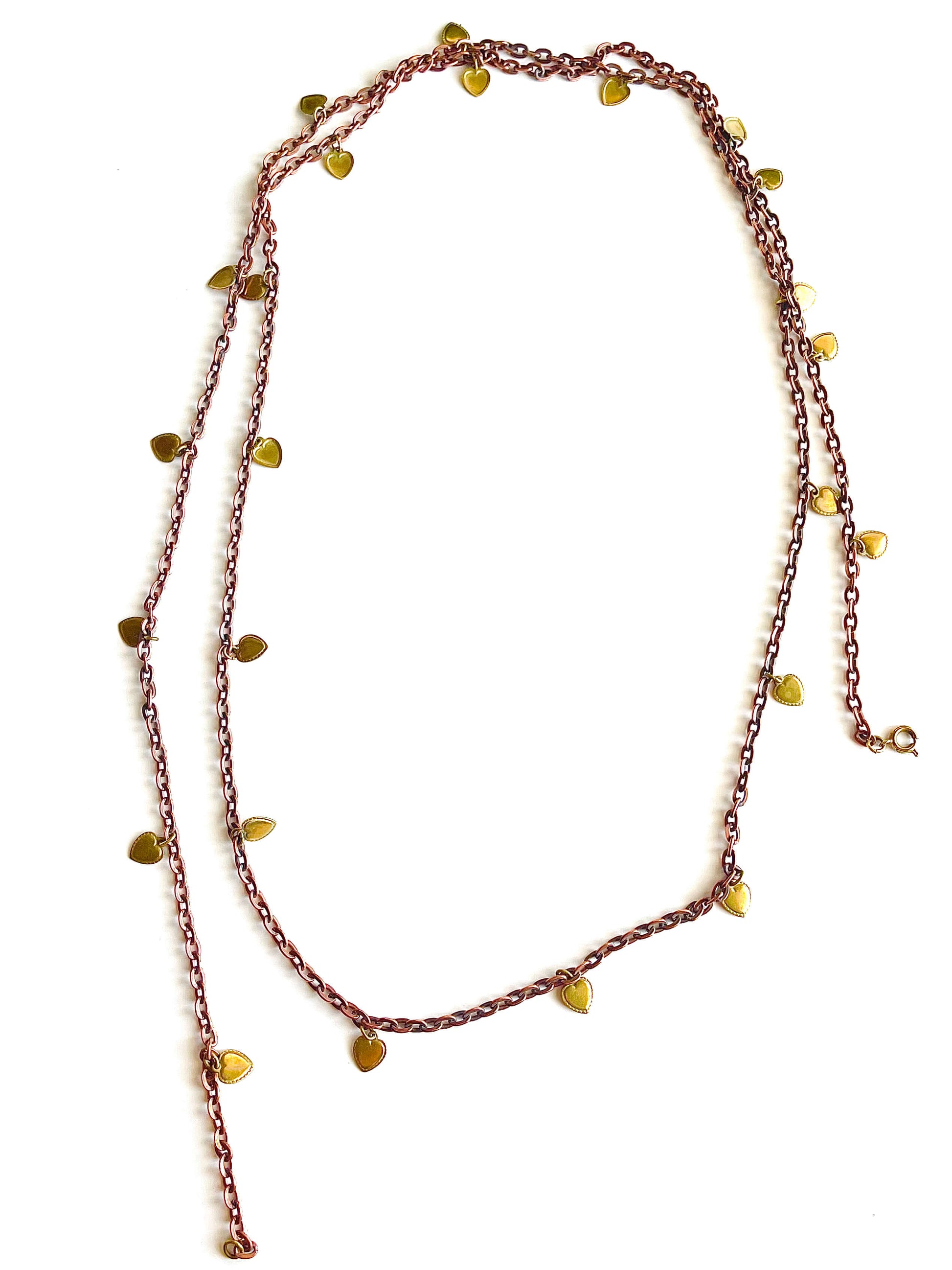 Copper brass necklace with yellow brass heart charms on a white backdrop
