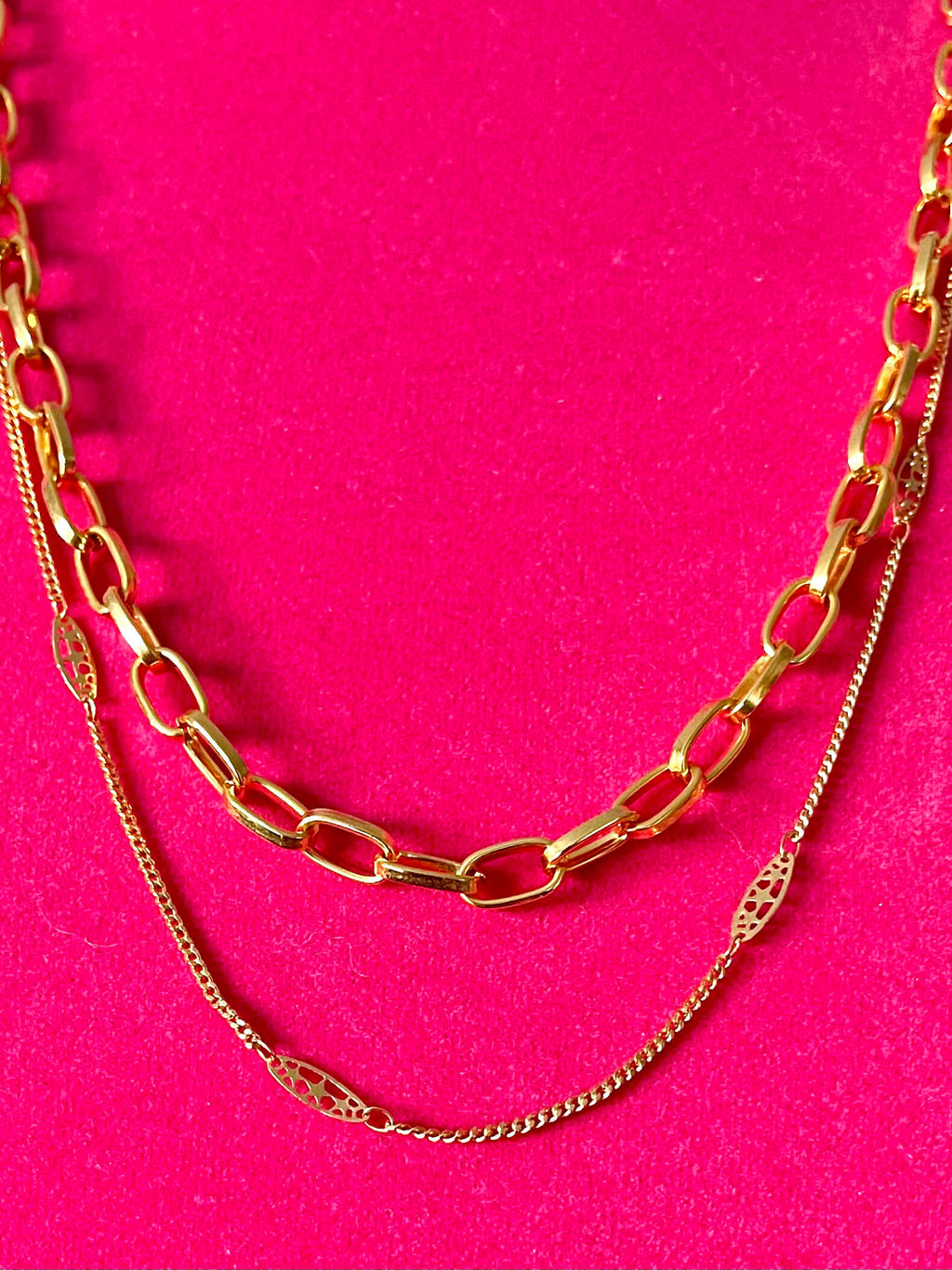 Yellow brass chains on a pink background 