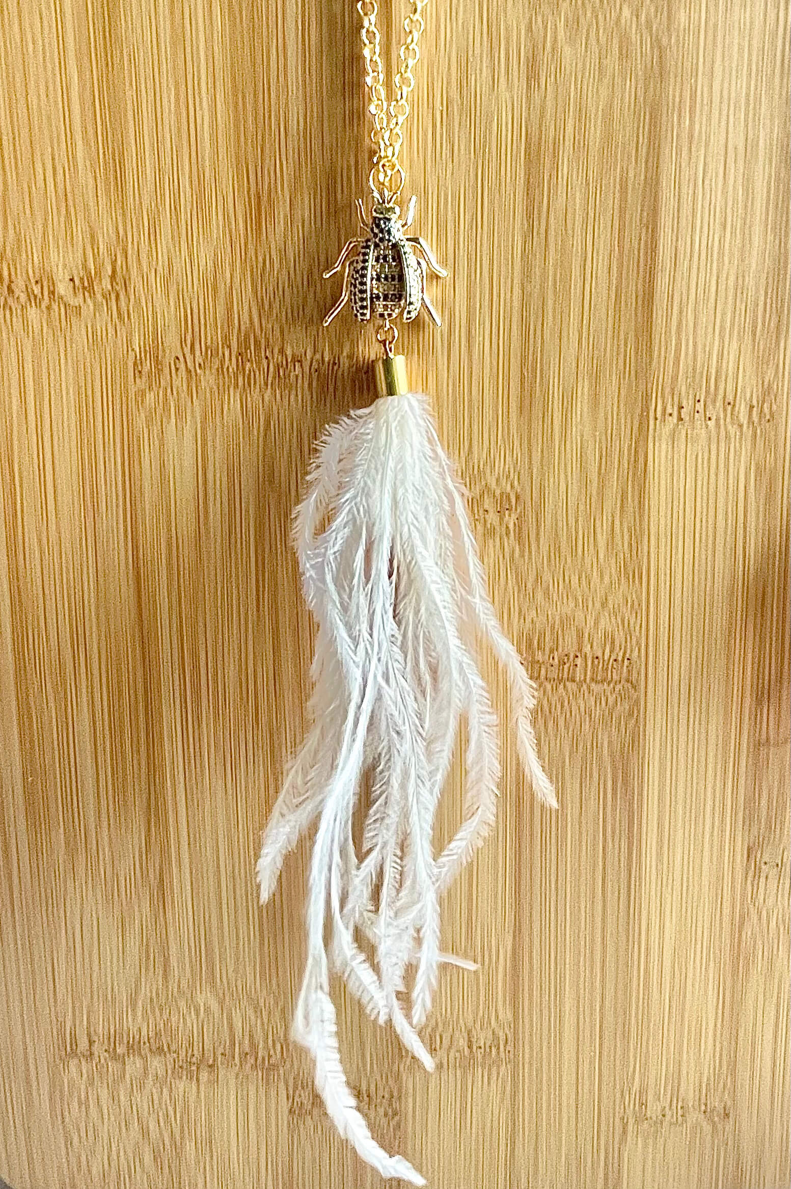 White ostrich feather and crystal bee pendant necklace