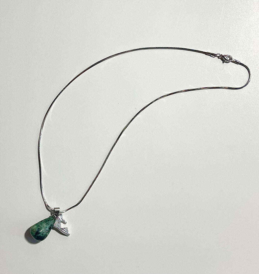 Silver necklace with shoe charm and teardrop zoisite with white backdrop